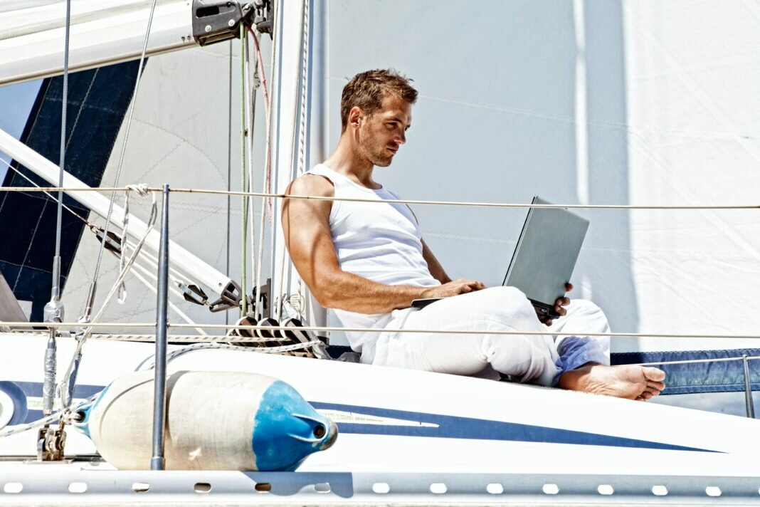 man on a boat with a laptop