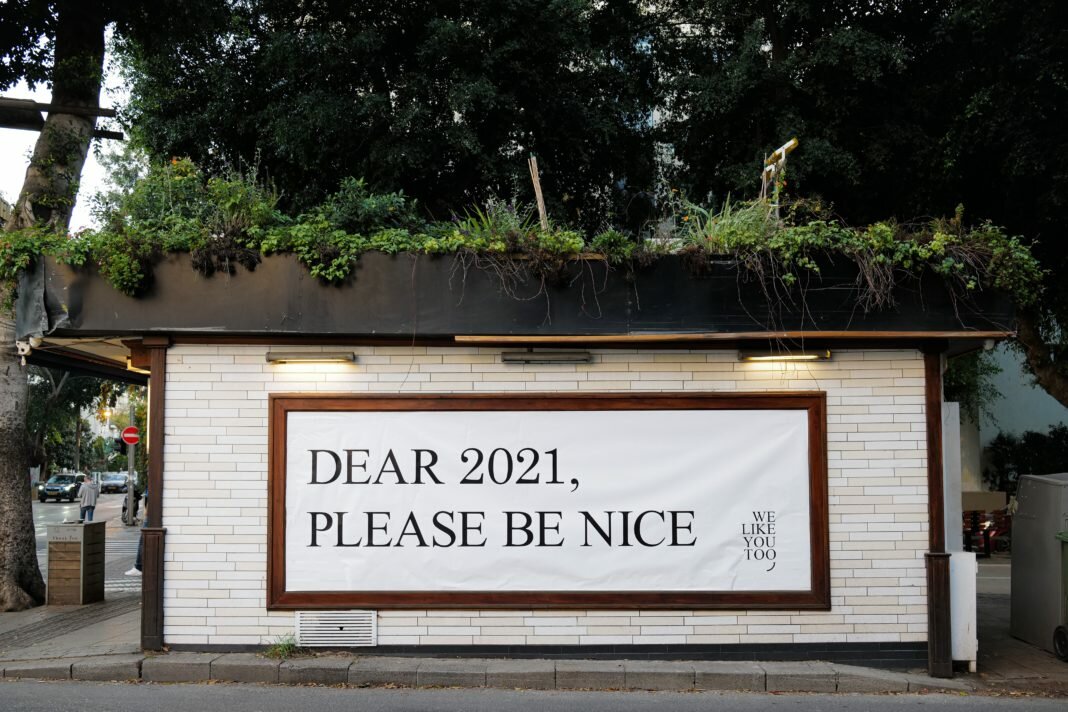 sign on building dear 2021 please be nice