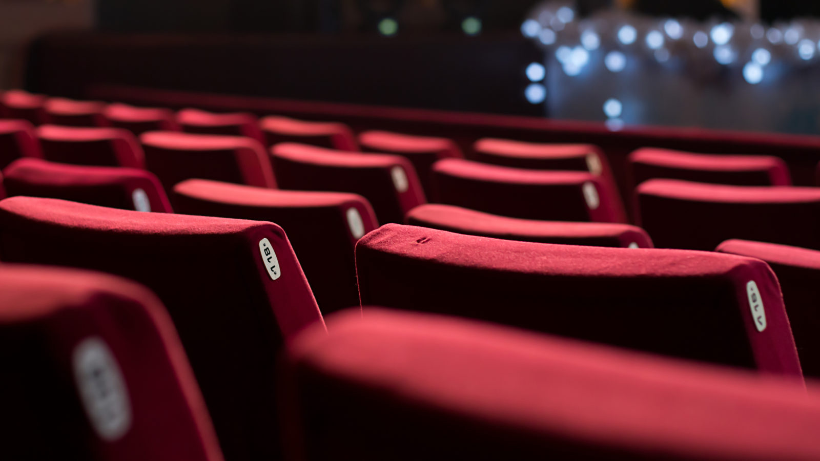 Empty theater with red chairs. Rear view. 2023/01/theatre-chairs-entertainment.jpeg 
