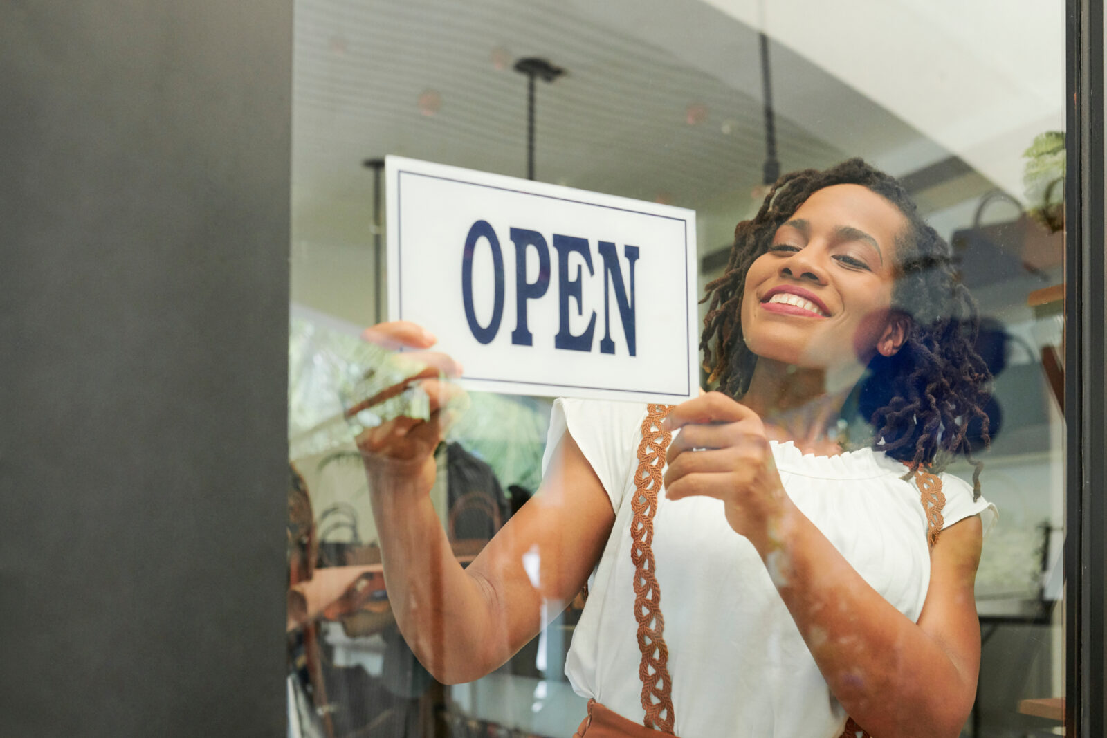 Pretty young Black woman opening her store in the morning 2023/05/AdobeStock_271211471.jpeg 