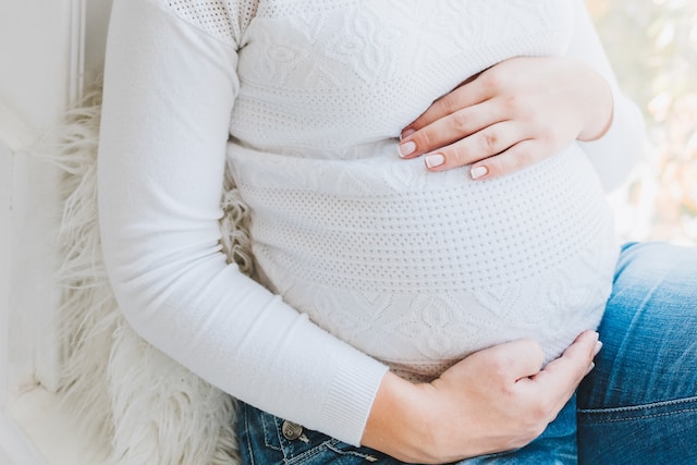 Pregnant woman holding belly