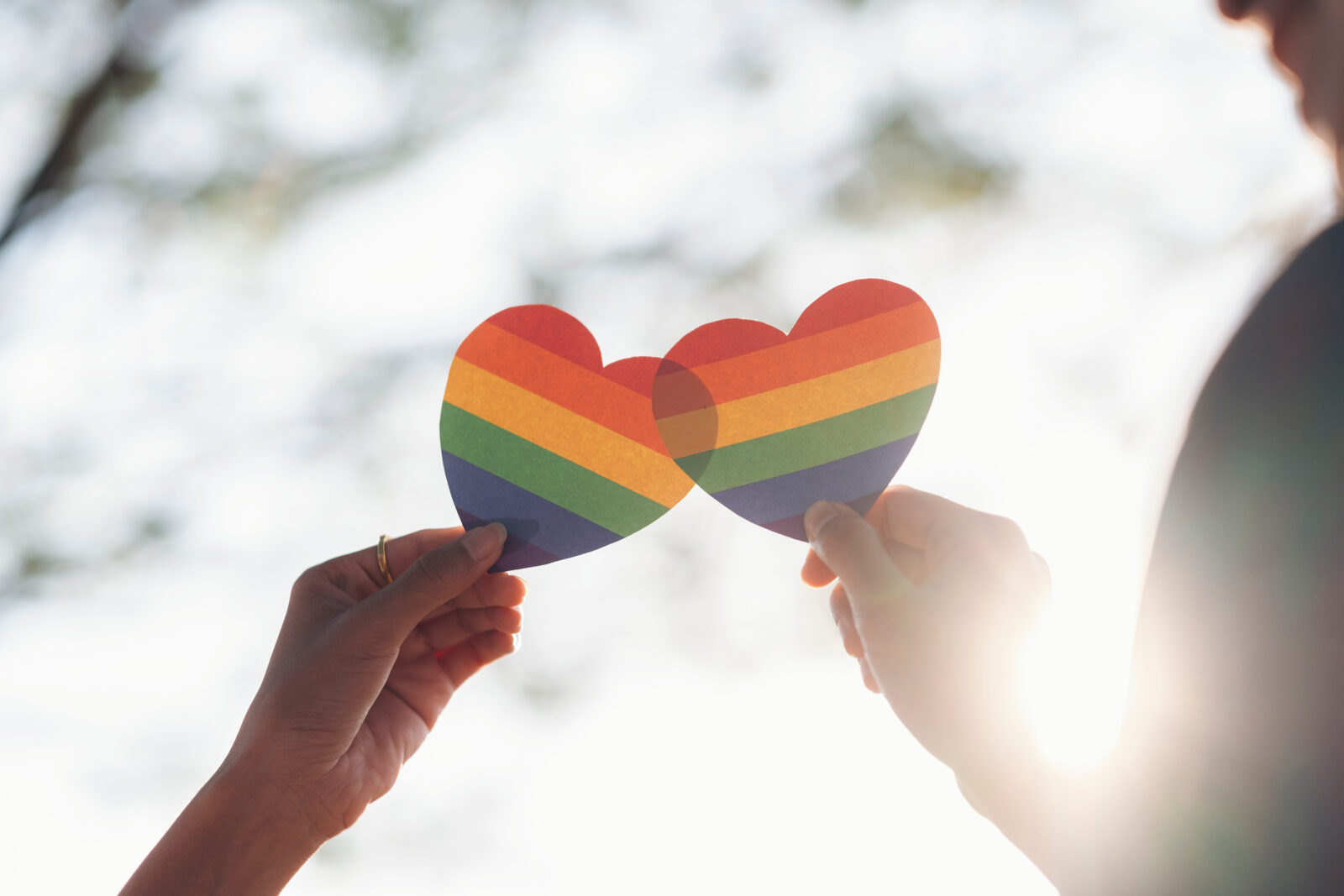 Close up hand of LGBTQ couple holding rainbow heart. LGBT rights concept. 2023/06/AdobeStock_310614650.jpeg 