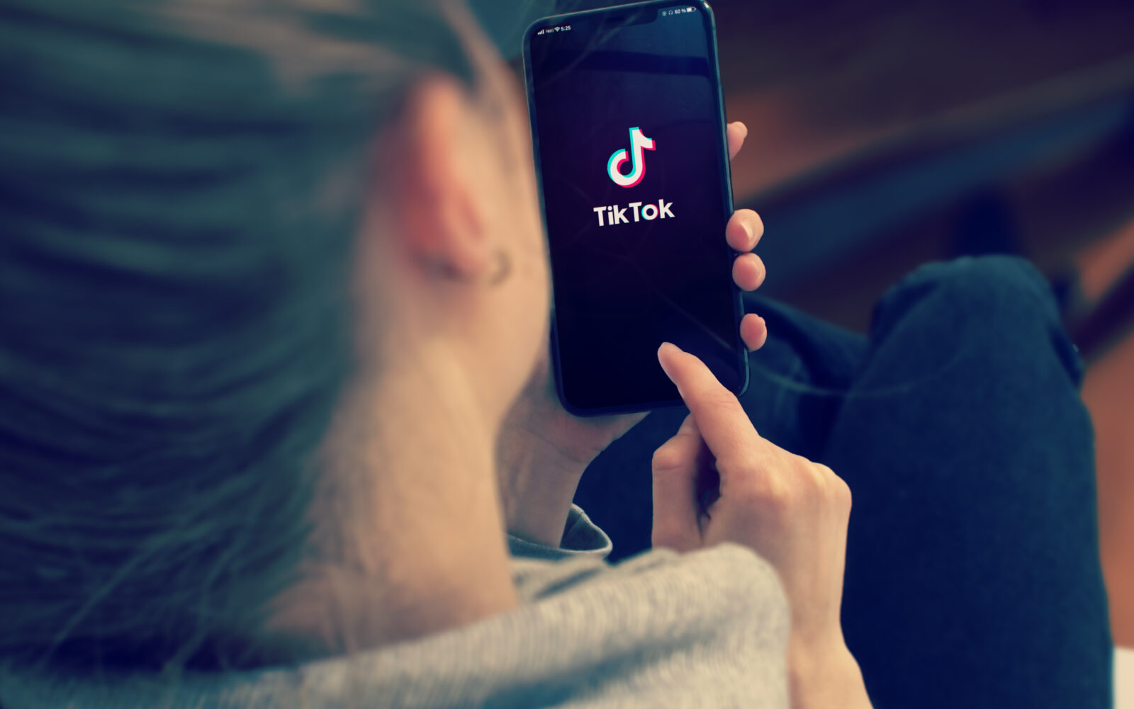 KYIV, UKRAINE-JANUARY, 2020: Tiktok on Smart Phone Screen. Young Girl Pointing or Texting Mobile Phone During a Pandemic Self-Isolation and Coronavirus Prevention. 2024/03/AdobeStock_356900210_Editorial_Use_Only.jpeg 