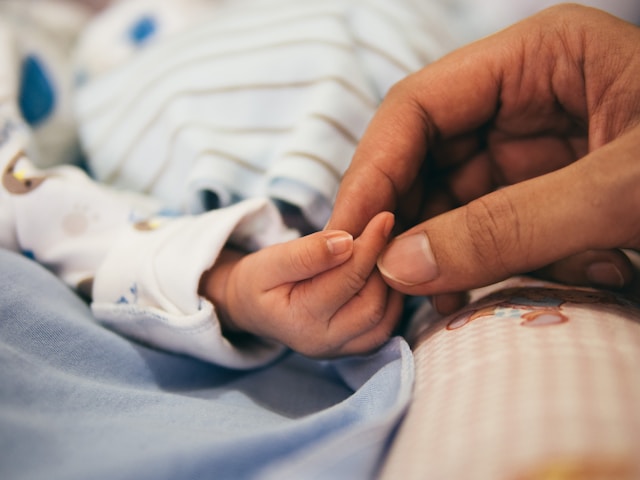 Woman holding baby's hand