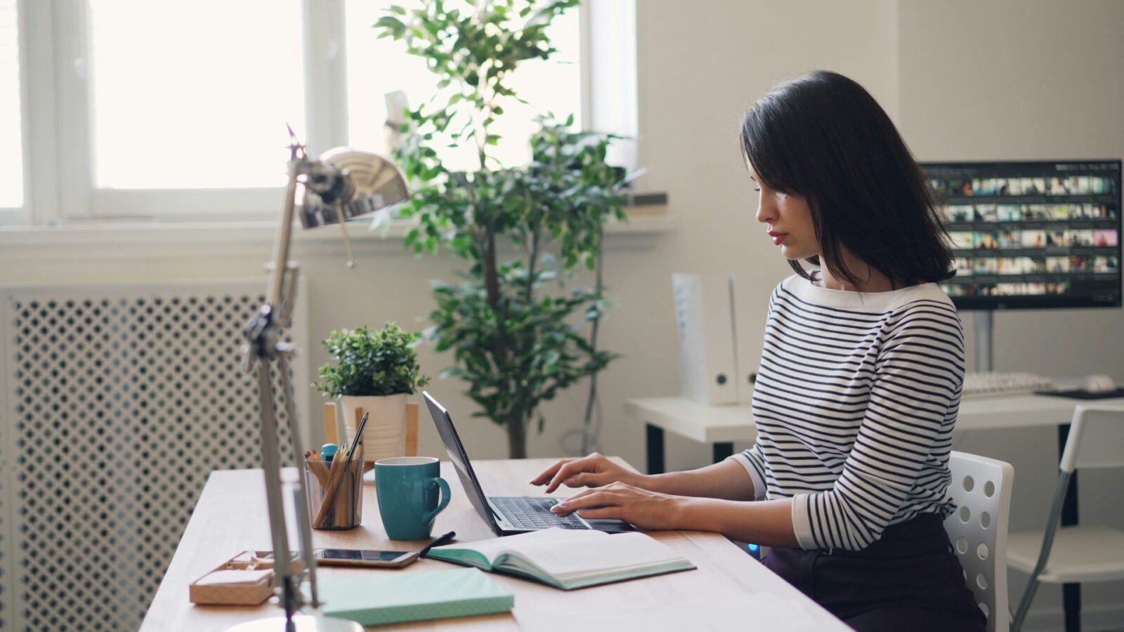 Woman working on her laptop at her desk