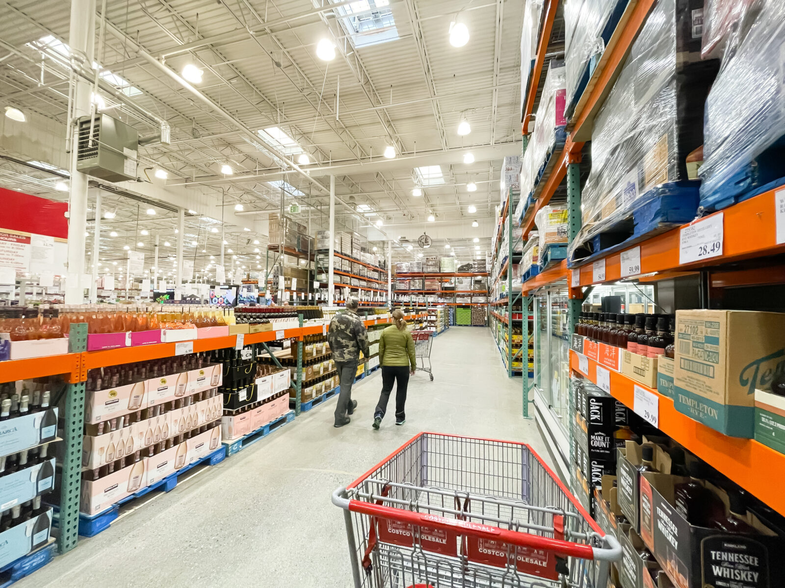 OCT 27, 2022-ANCHORAGE, AK, US: Rear view customer shopping for wines, champagne boxes and case at Liquor store inside Costco Wholesale store in Alaska. Costco sells many alcohol and spirits 2024/11/AdobeStock_541580079_Editorial_Use_Only.jpeg 