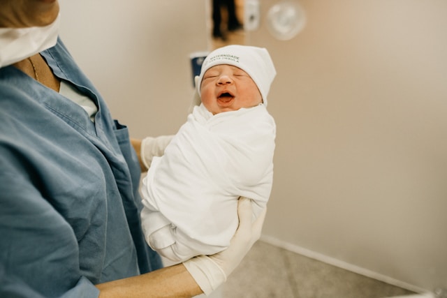 Woman holding newborn baby