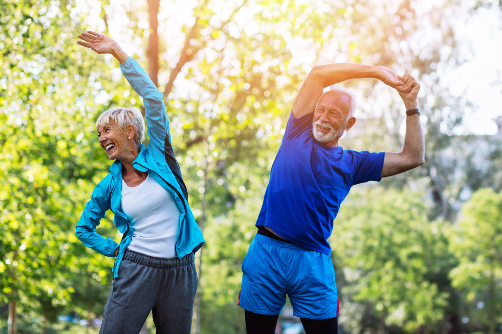 Happy fit senior couple exercising in park. 2024/12/AdobeStock_218536965.jpeg 