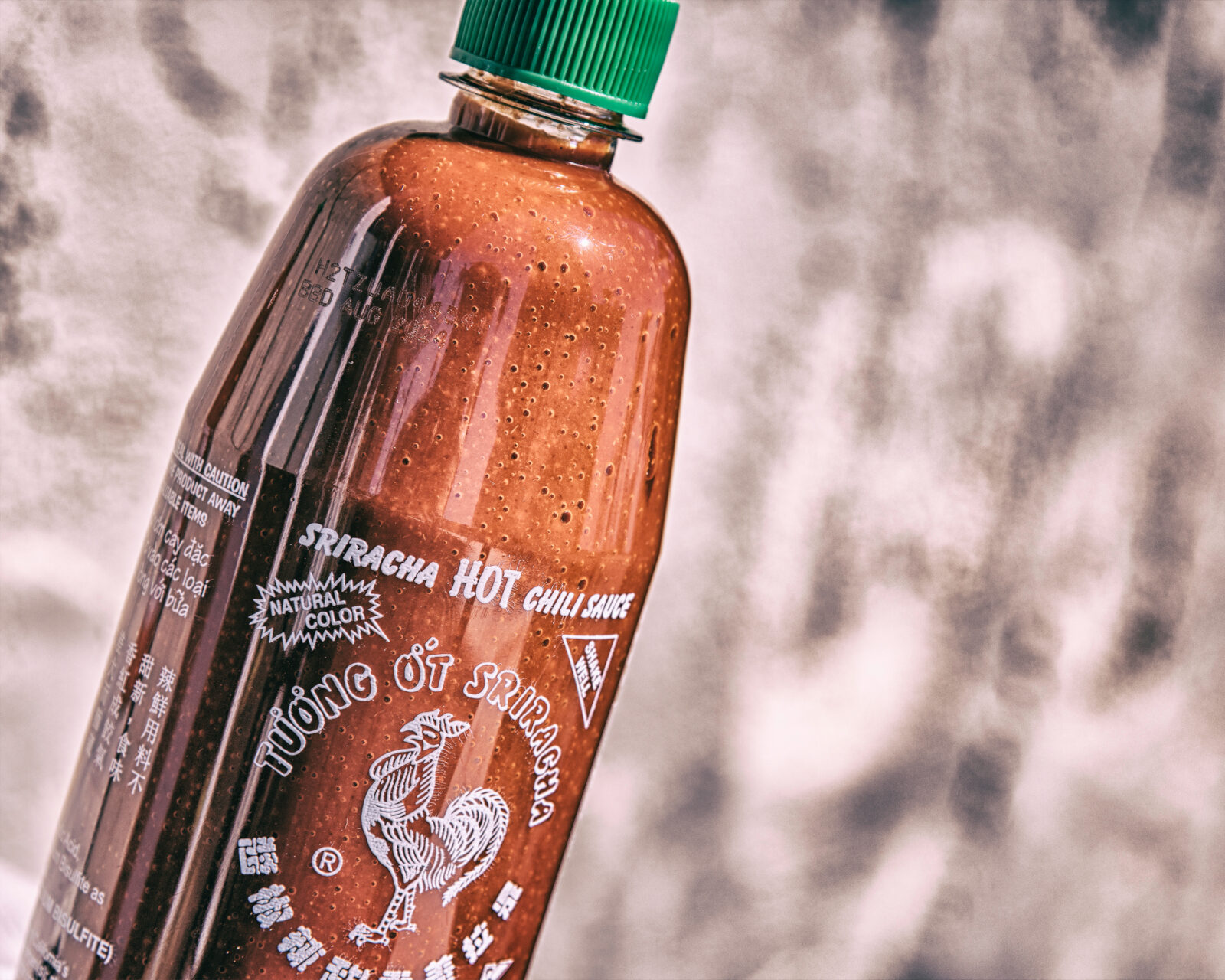 Los Angeles, CA, USA – June 14, 2023: A close up of Sriracha hot chili sauce bottle in Los Angeles CA. Due to a shortage of chili peppers the sauce is currently in high demand. 2025/01/AdobeStock_623621972_Editorial_Use_Only.jpeg 