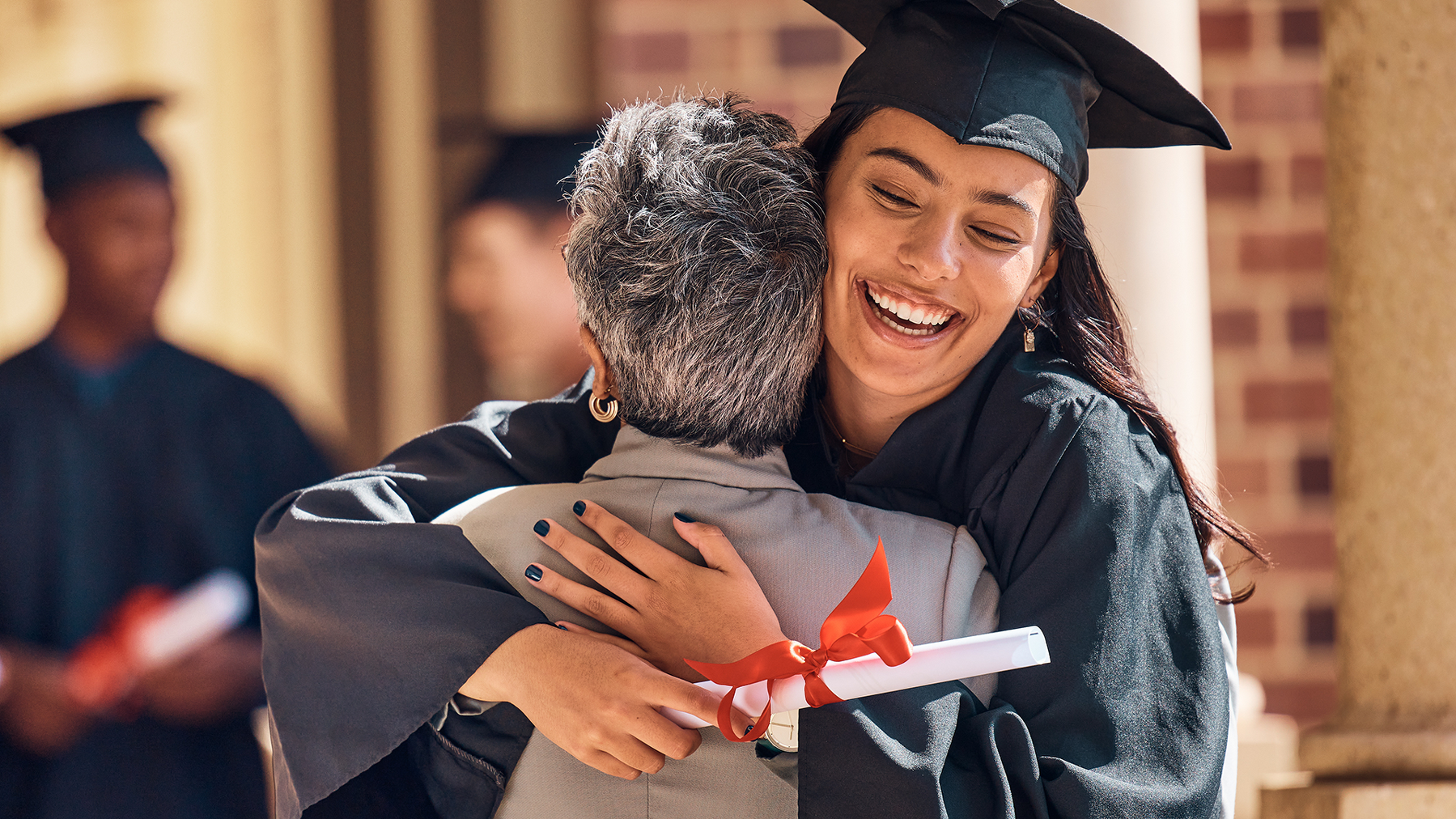 Hug, graduation and graduate, women and education achievement, success on university campus and certificate with academic goals reached. College, student