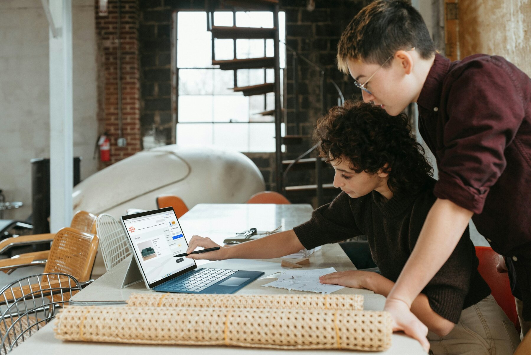 Man and woman looking at a laptop on a table