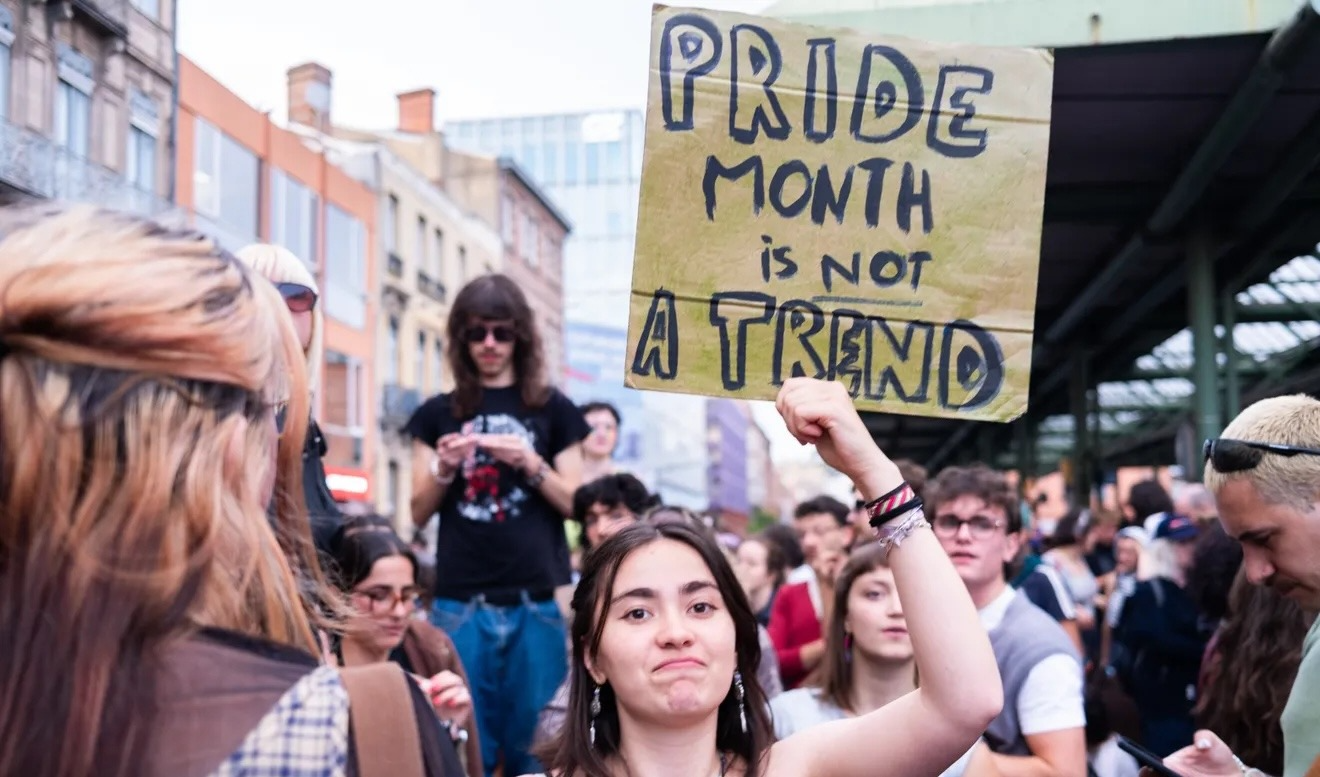 Someone holding up sign in protest that says pride month is not a trend